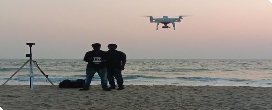 Survey team flying a drone at the coast